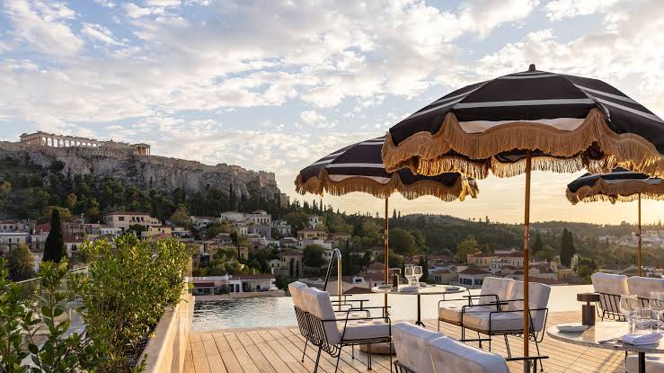 Rooftop terrace with fringed parasols overlooking the Acropolis