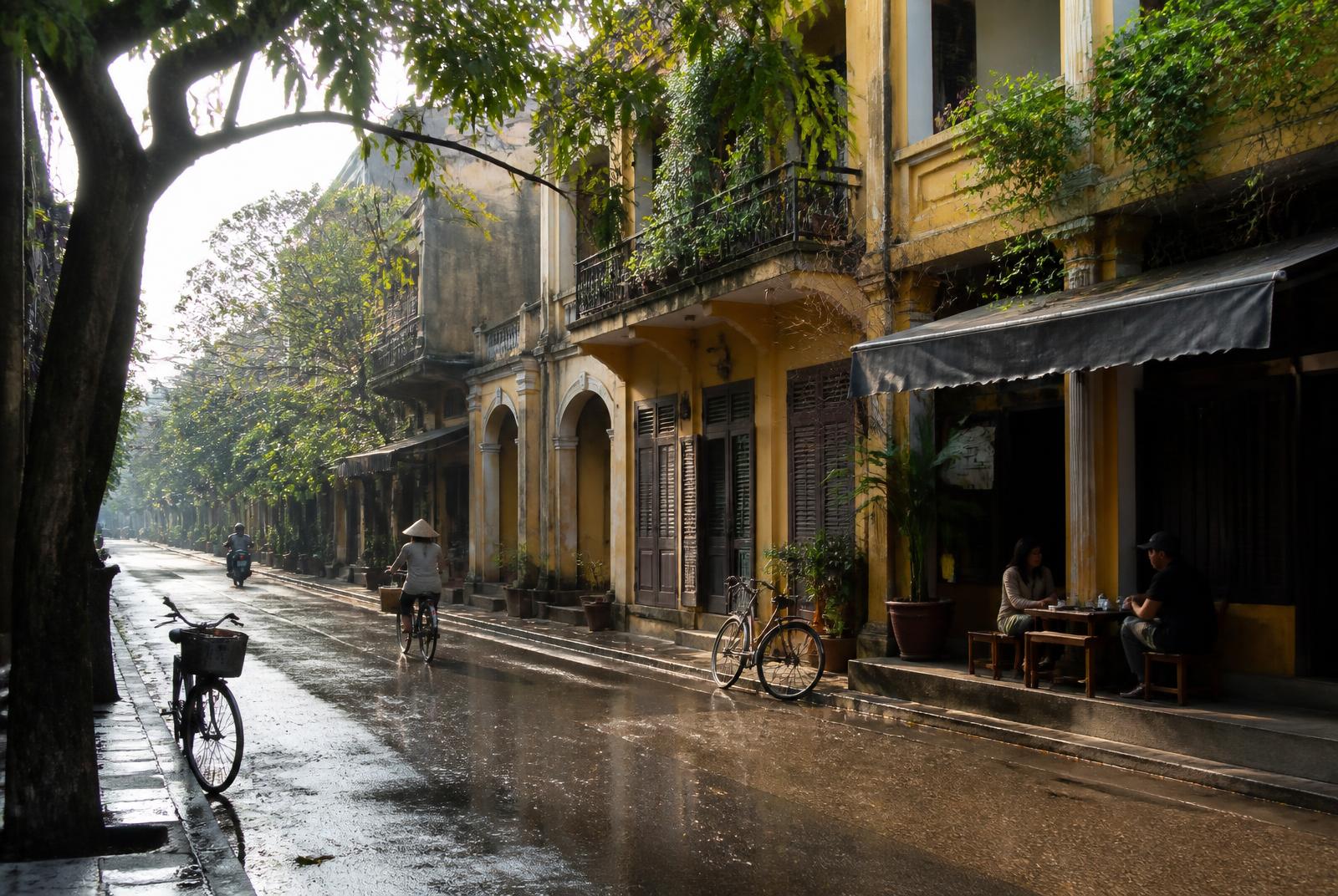 A quiet tree-lined street in Hanoi's Old Quarter after rain
