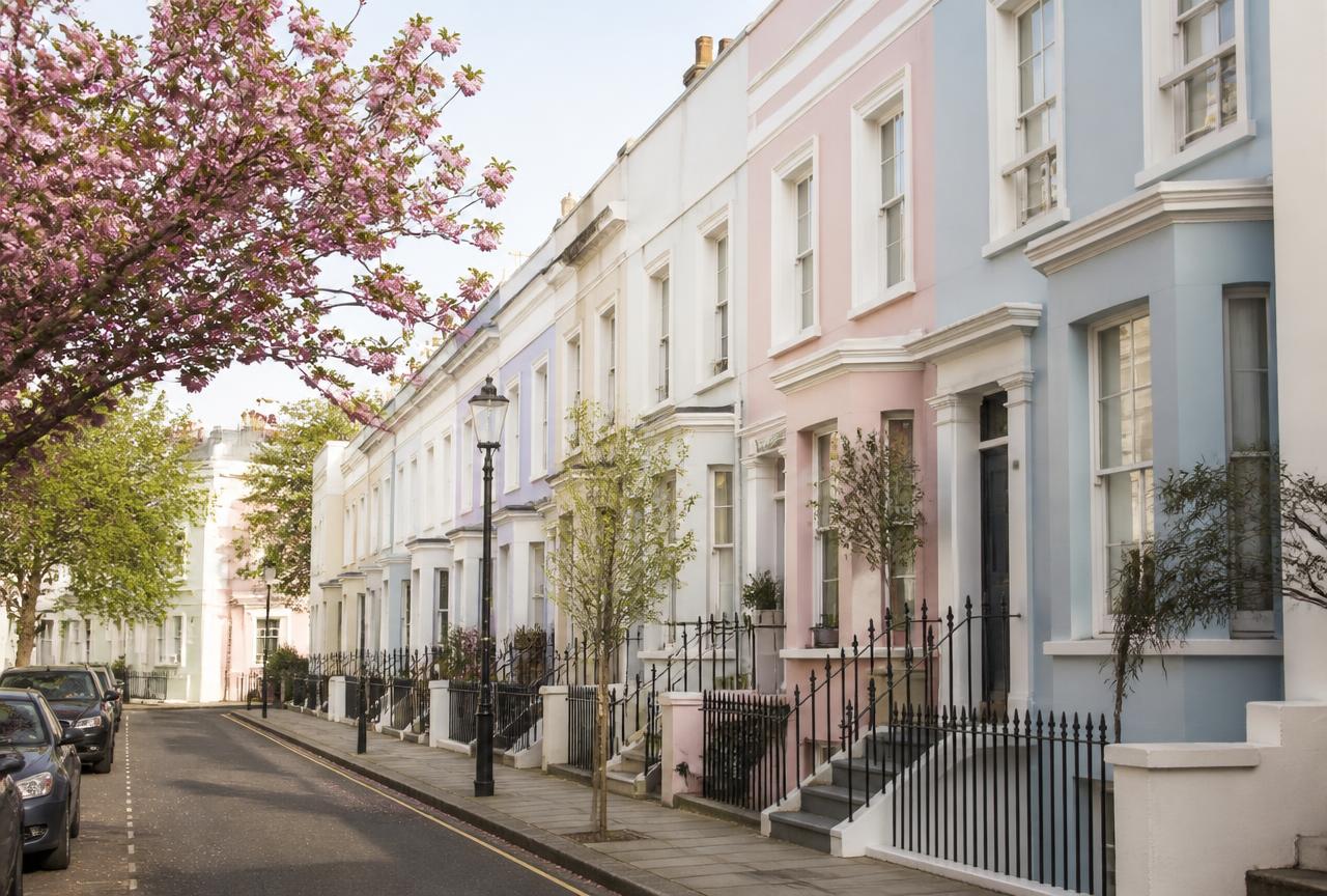 Pastel Notting Hill townhouses on a quiet London street in spring