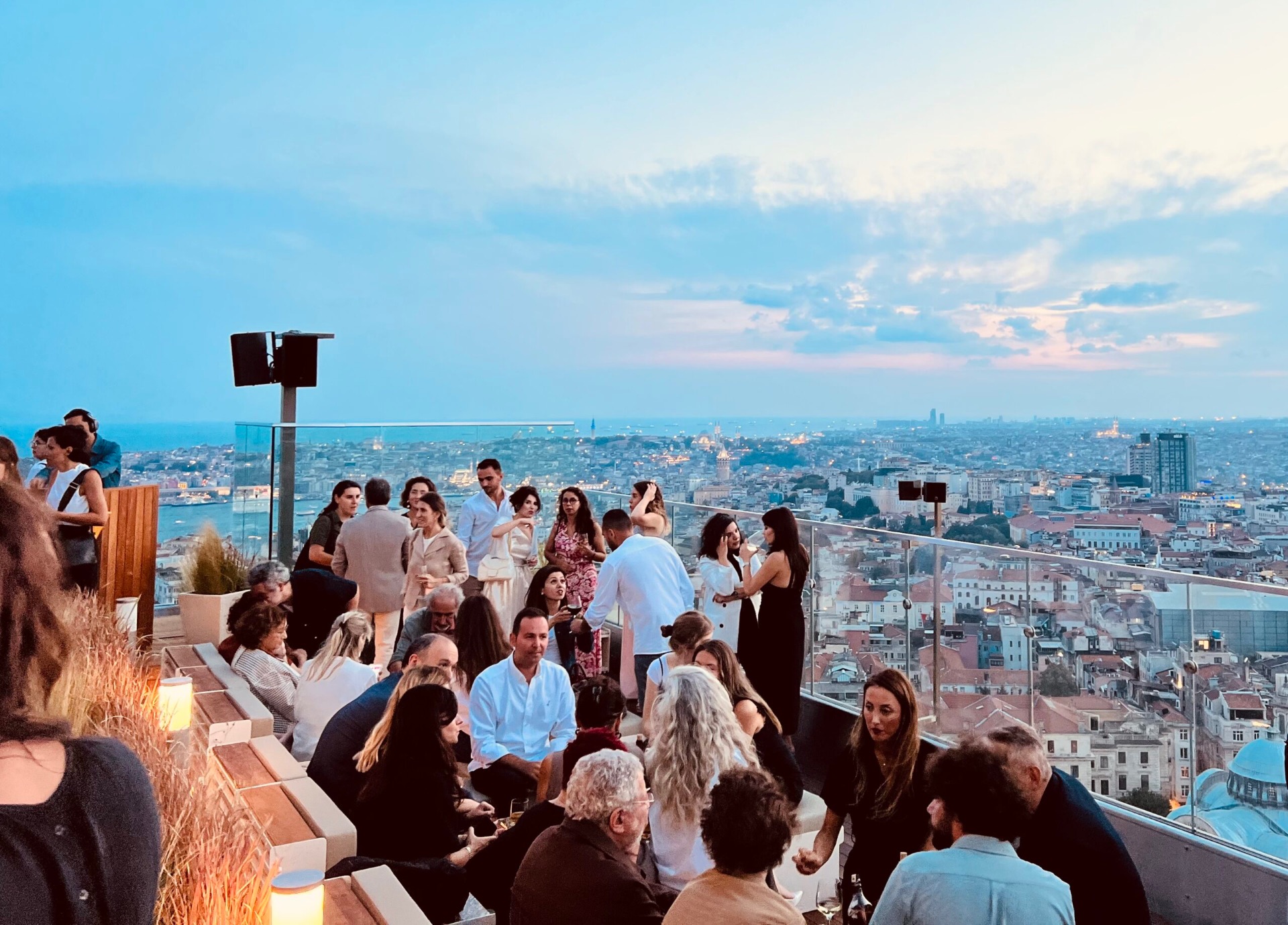 Rooftop terrace above Istanbul with the Bosphorus and city lights at dusk